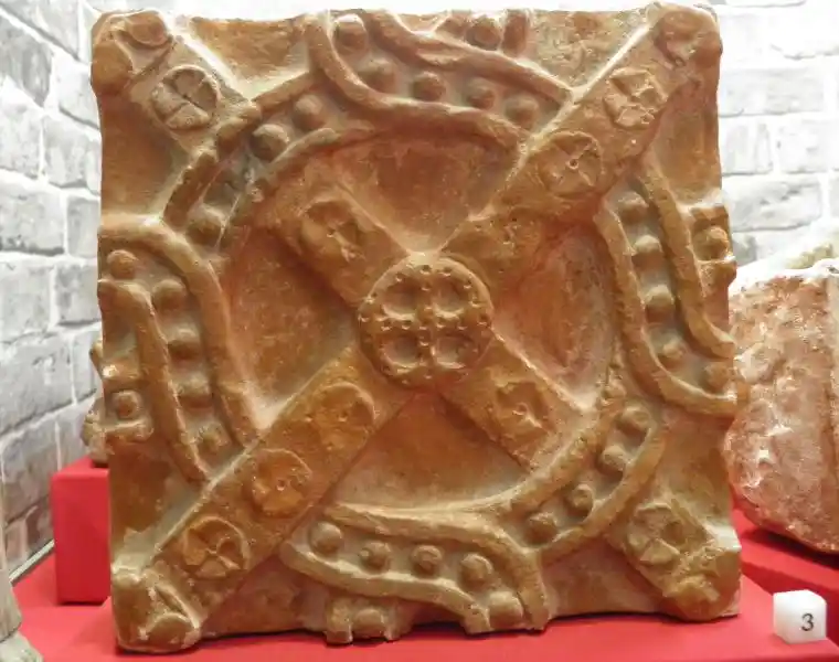 A cross on a stone with solar disc